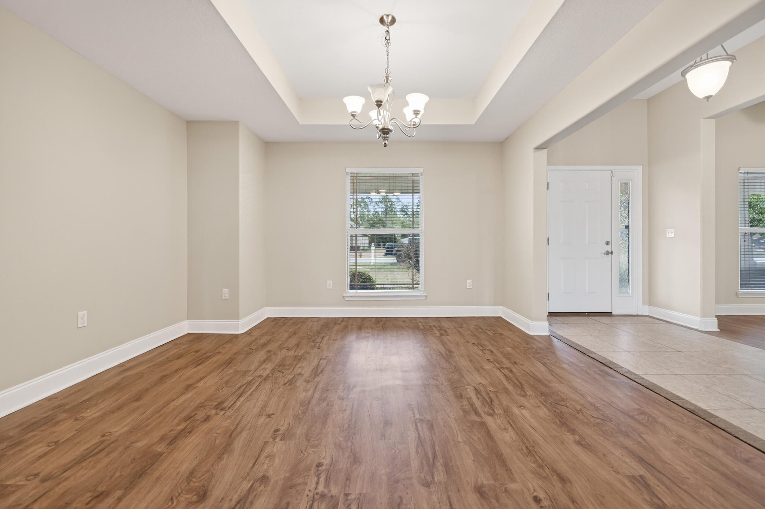6210 Lapis Lane Crestview, FL 32539 - Photo 21 of 72 a view of an empty room with wooden floor and a window