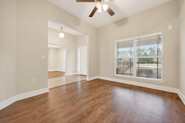 a view of an empty room with a ceiling fan
