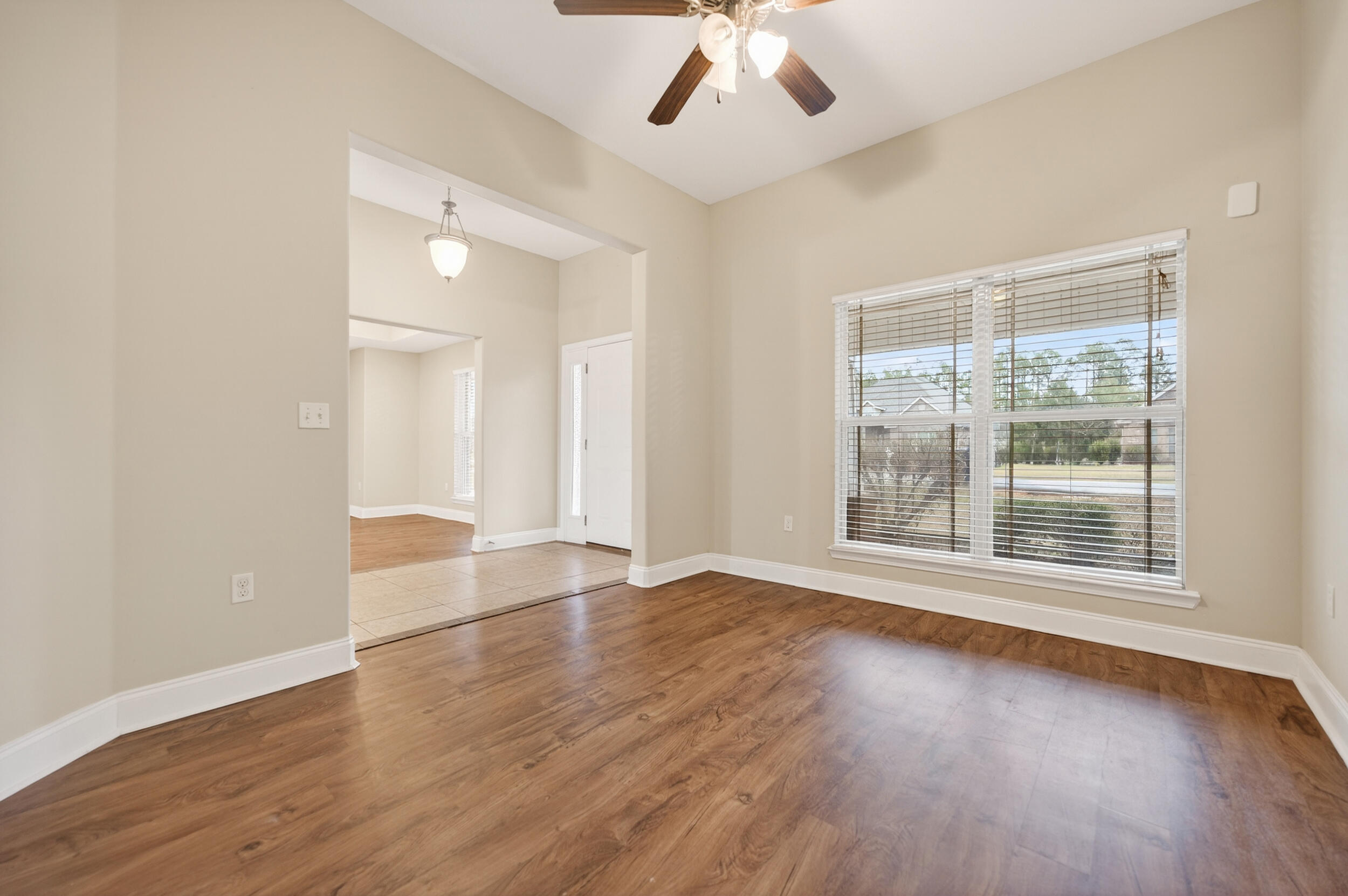 6210 Lapis Lane Crestview, FL 32539 - Photo 25 of 72 an empty room with wooden floor and windows