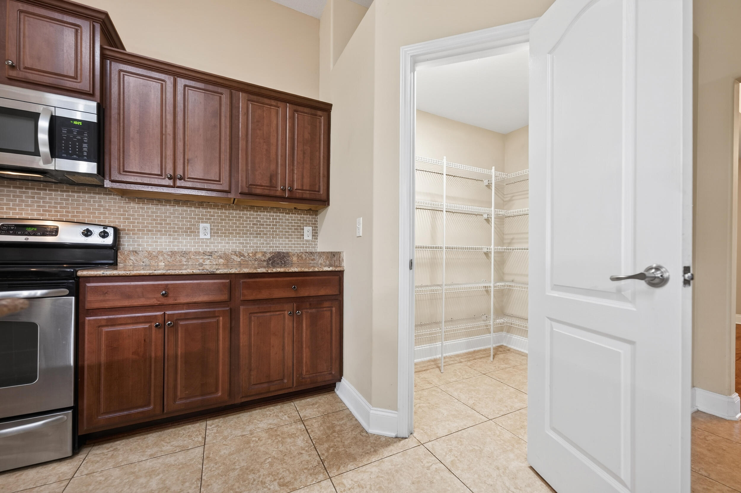 6210 Lapis Lane Crestview, FL 32539 - Photo 29 of 72 a kitchen with stainless steel appliances granite countertop a refrigerator and a sink