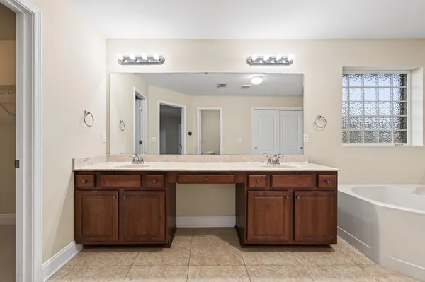 a bathroom with a granite countertop sink a toilet and shower