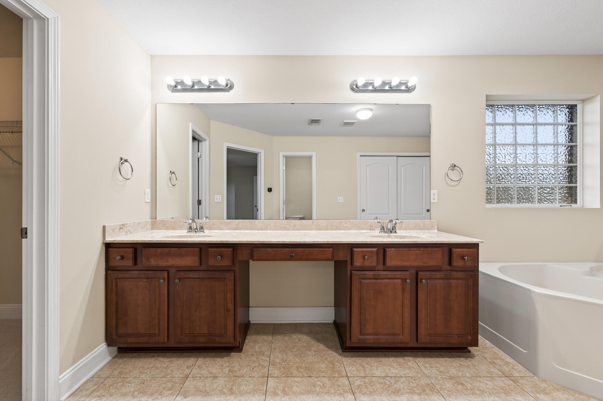 6210 Lapis Lane Crestview, FL 32539 - Photo 36 of 72 a spacious bathroom with a granite countertop sink two mirror and bathtub