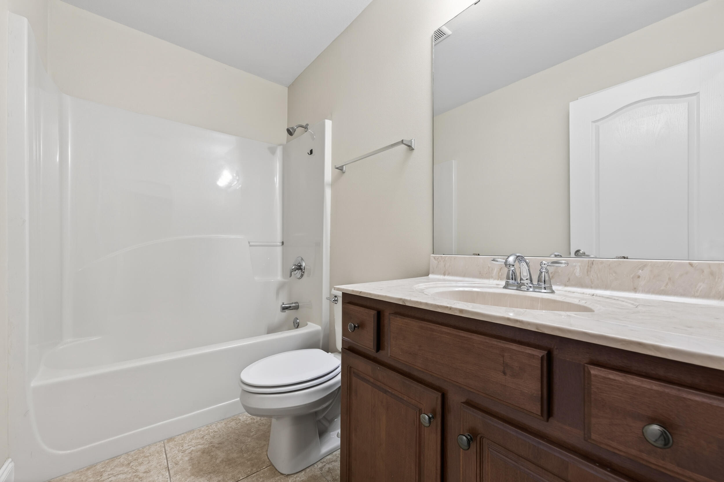 6210 Lapis Lane Crestview, FL 32539 - Photo 47 of 72 a bathroom with a granite countertop sink a toilet and shower
