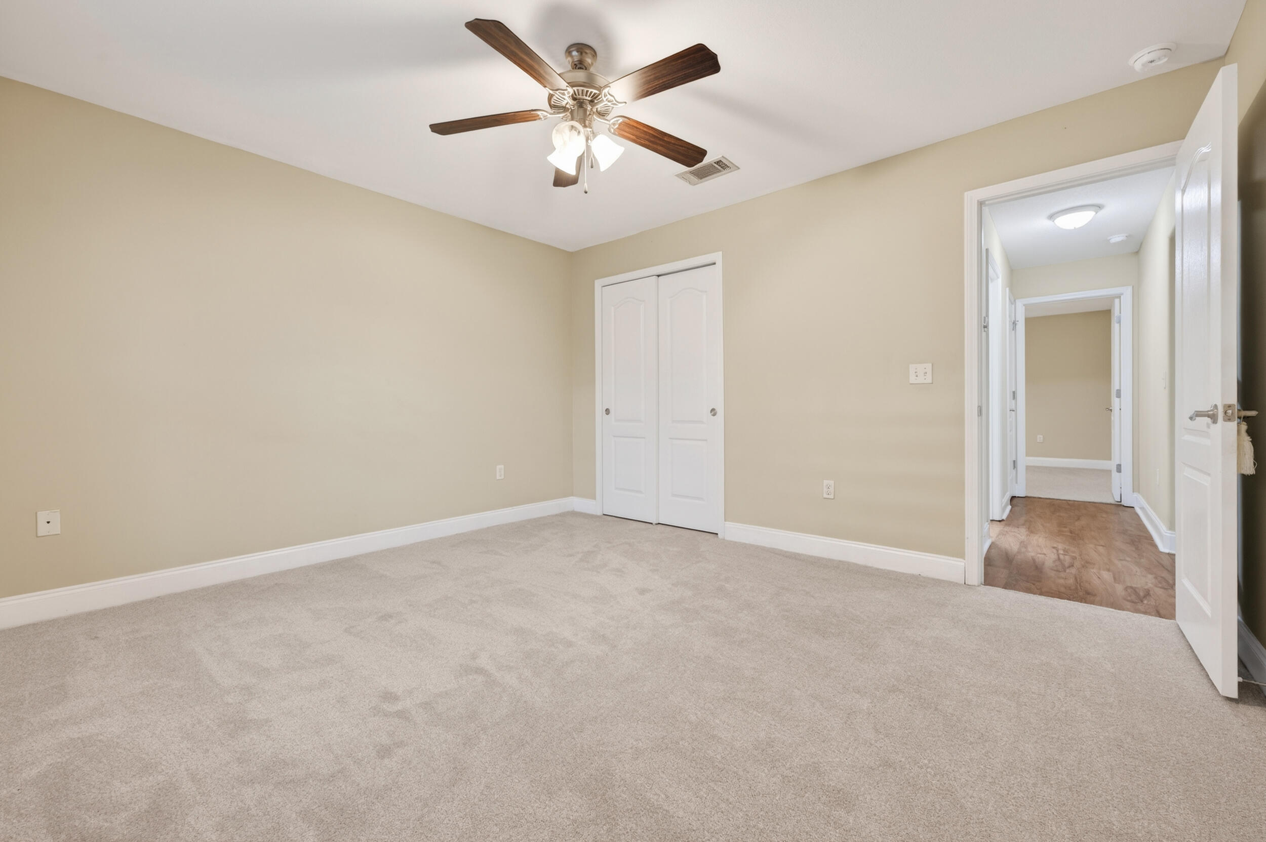 6210 Lapis Lane Crestview, FL 32539 - Photo 50 of 72 an empty room with a chandelier fan and windows