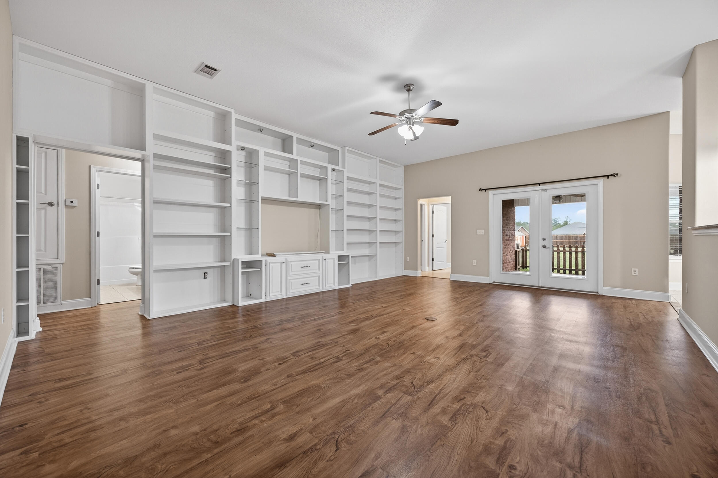 6210 Lapis Lane Crestview, FL 32539 - Photo 9 of 72 a view of an empty room with a window and wooden floor