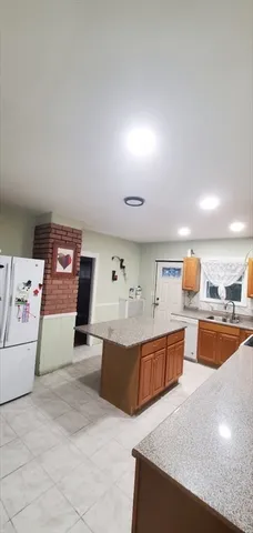 a living room with furniture and kitchen view