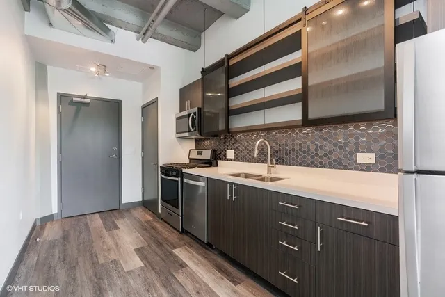 a kitchen with a sink and cabinets