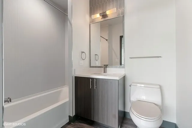 a bathroom with a sink a toilet and a mirror