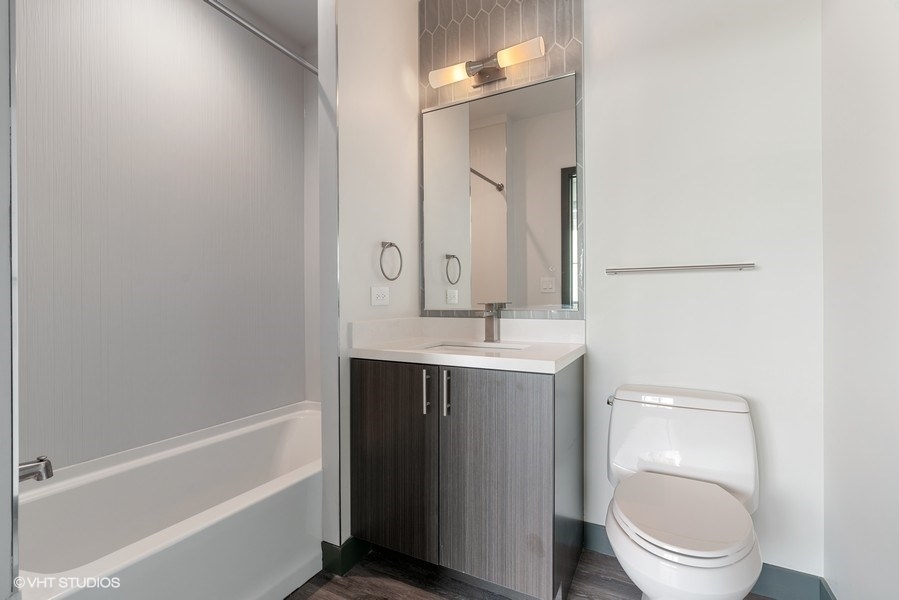 2101 South Wabash Avenue, Unit 402 Chicago, IL 60616 - Photo 7 of 9 a bathroom with a sink a toilet and a mirror