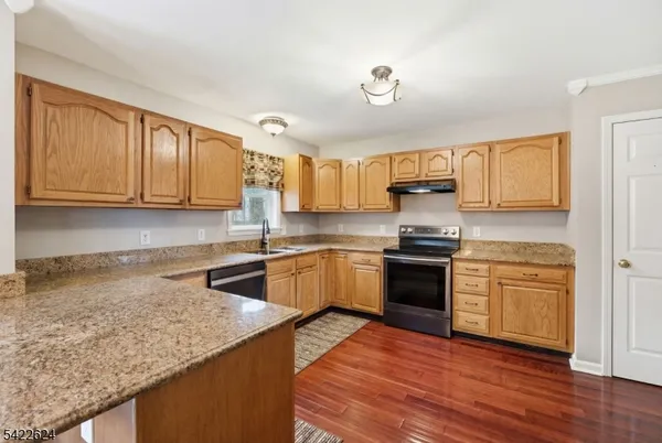 a dining room with furniture a chandelier and wooden floor