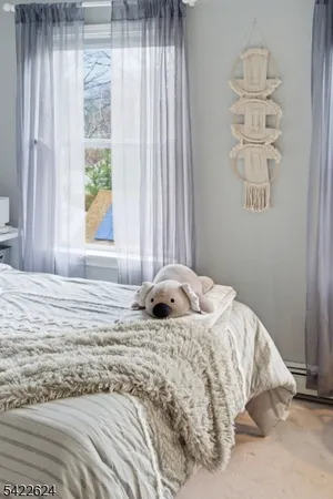 a bedroom with a bed and a book shelf