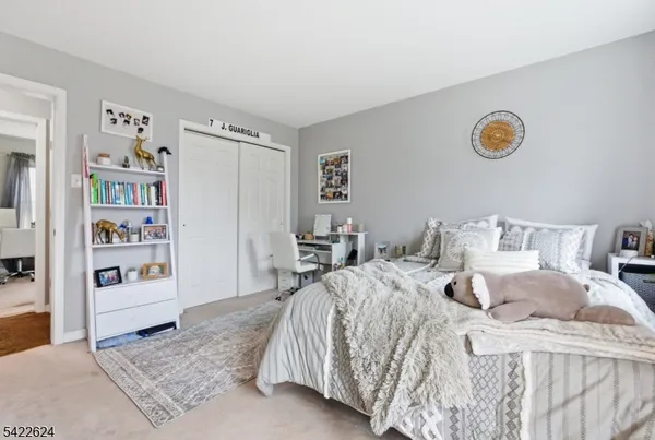 a bedroom with a bed and a desk