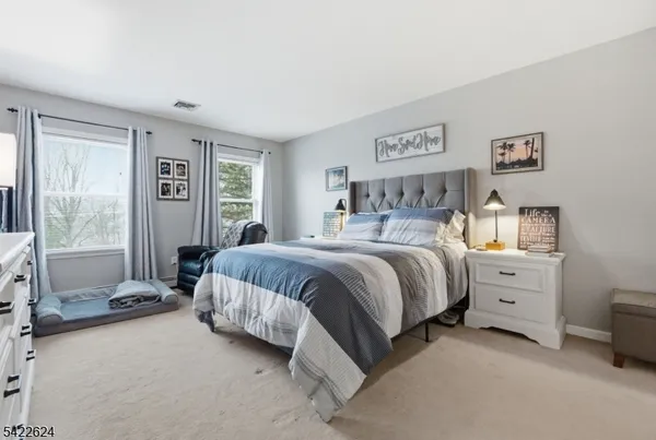 a bedroom with a bed and lamp