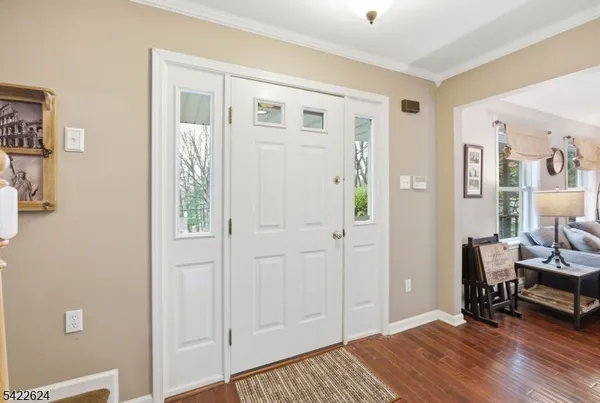 a view of entryway and livingroom with wooden floor