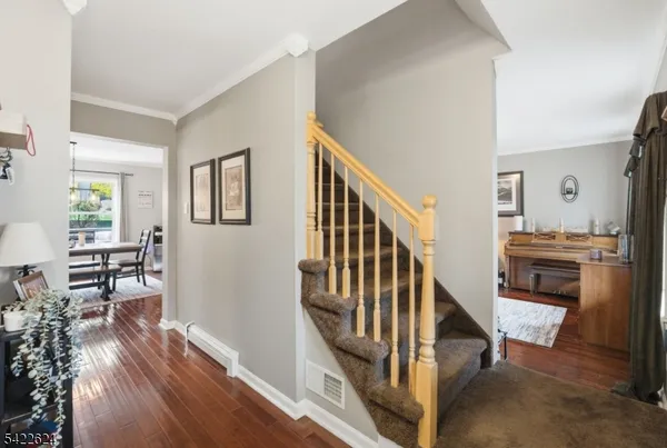 a living room with furniture a piano and a table