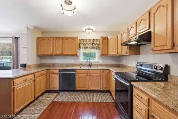a kitchen with granite countertop wooden cabinets and a granite counter tops