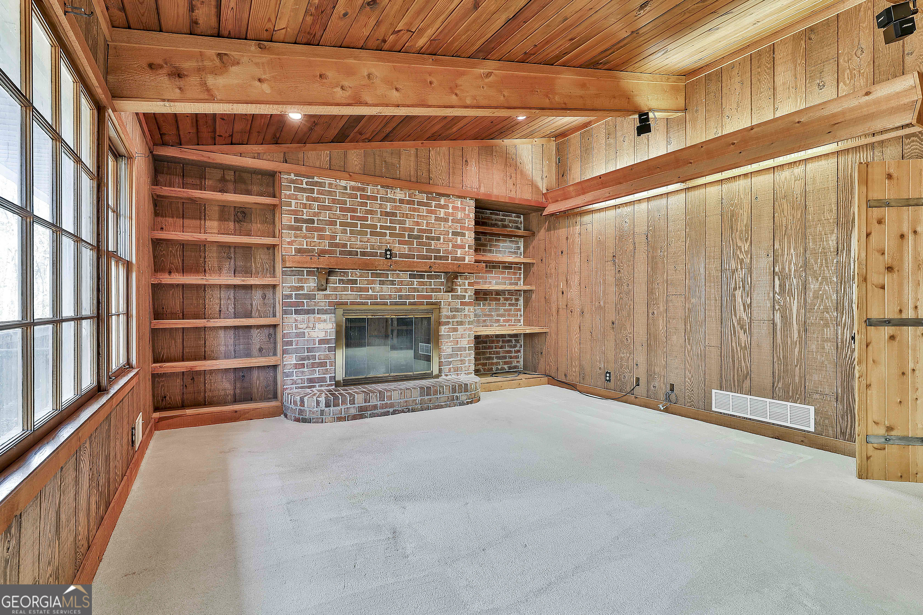 161 Mockingbird Lane Brooks, GA 30205 - Photo 15 of 57 a view of an empty room with a fireplace and a window