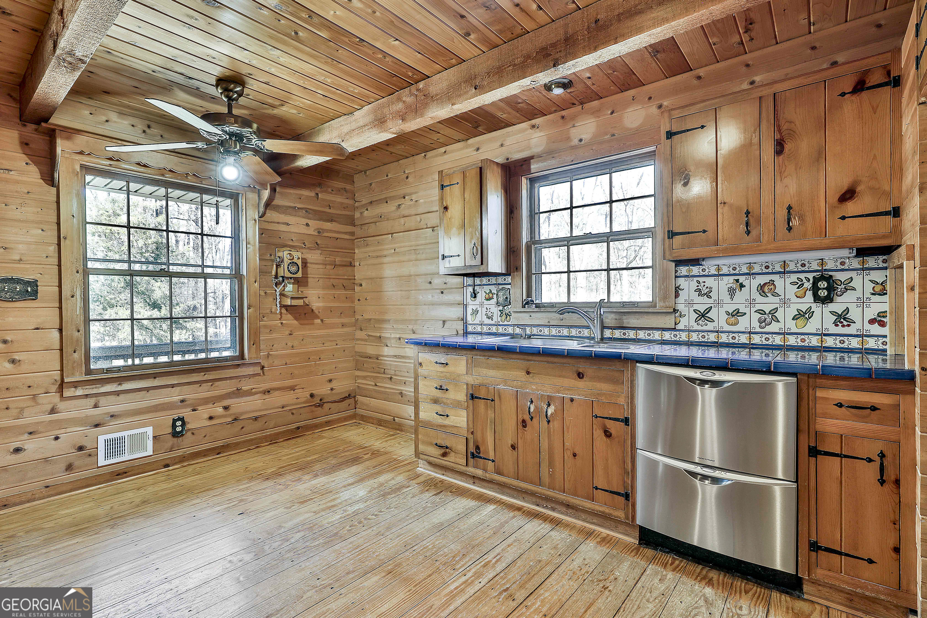 161 Mockingbird Lane Brooks, GA 30205 - Photo 21 of 57 a kitchen with granite countertop wooden floors and white appliances