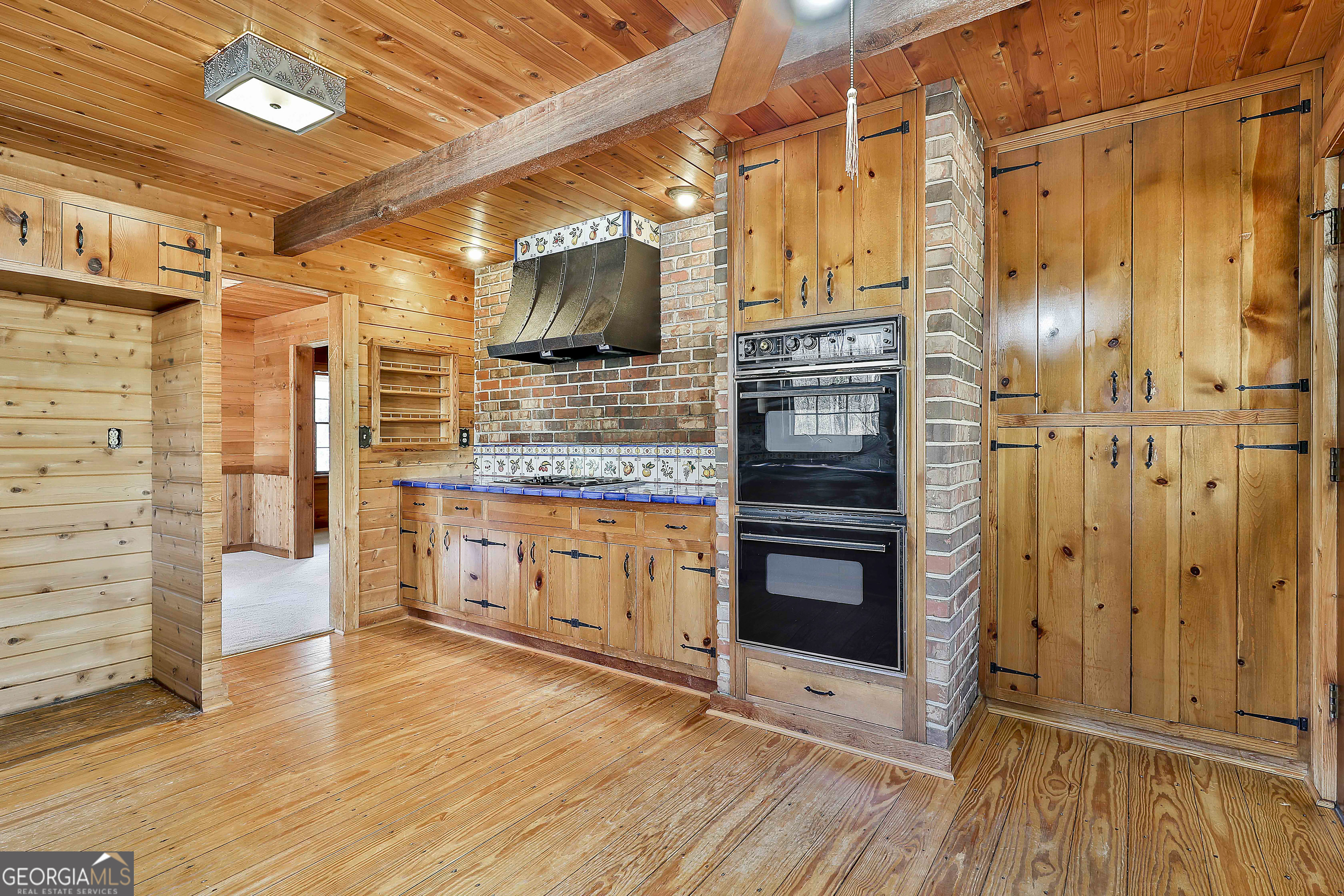 161 Mockingbird Lane Brooks, GA 30205 - Photo 24 of 57 a kitchen with stainless steel appliances and wooden floor