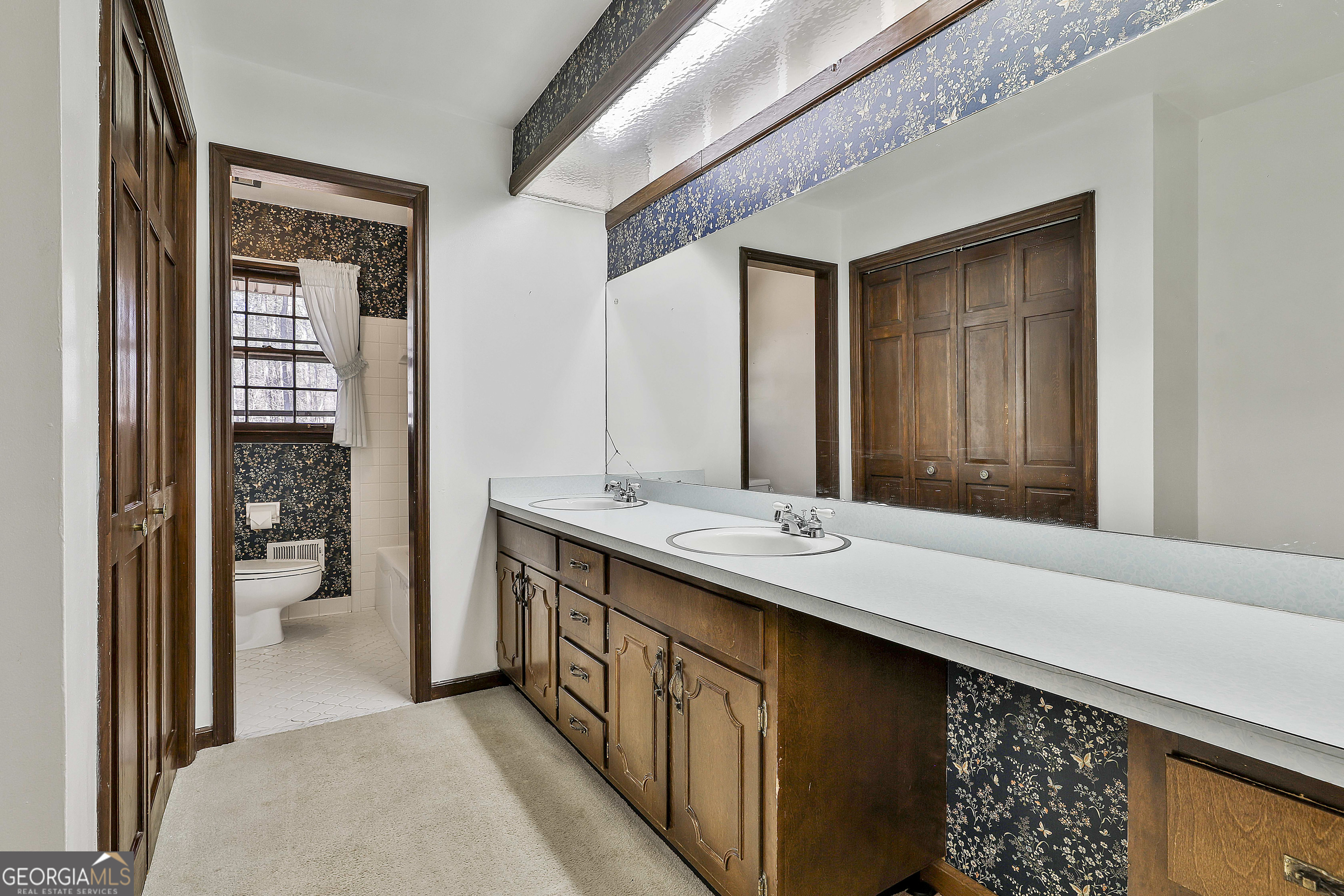 161 Mockingbird Lane Brooks, GA 30205 - Photo 27 of 57 a bathroom with a double vanity sink and a mirror