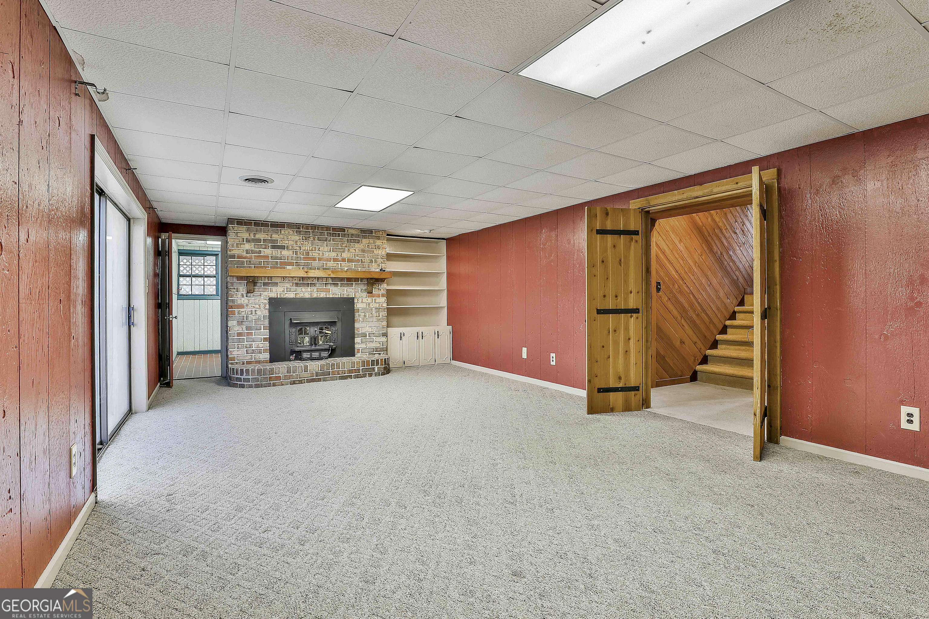161 Mockingbird Lane Brooks, GA 30205 - Photo 33 of 57 an empty room with furniture and a fireplace