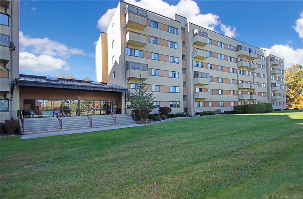 2 Putter Drive, Unit 102 Wallingford, CT 06492 - Photo 1 of 1 a view of a building with a yard
