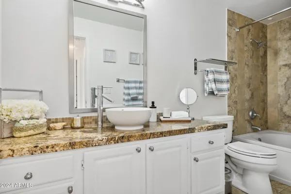 a bathroom with a bathtub shower sink and toilet
