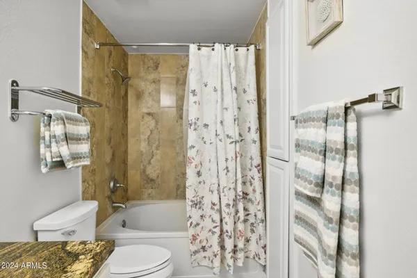 a front view of a building with palm trees