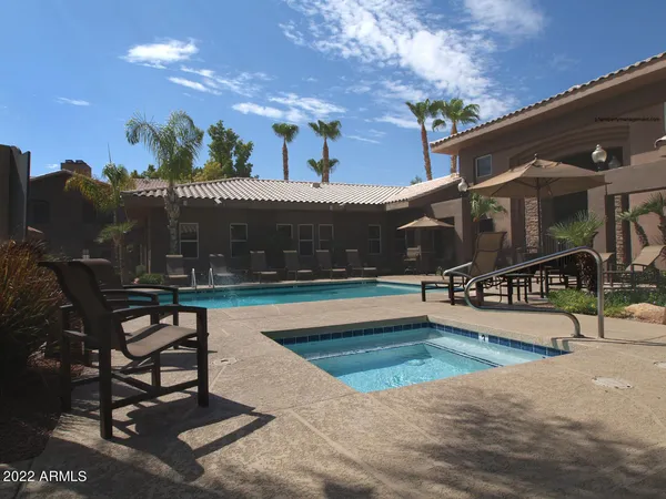 a view of a house with a yard and sitting area