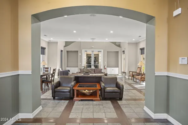 a living room with furniture and large windows