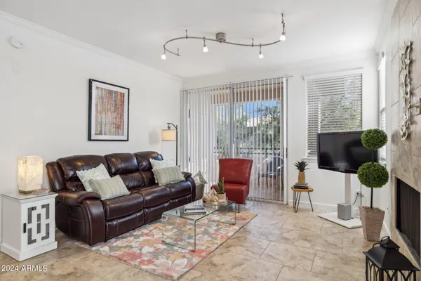 a living room with furniture and a floor to ceiling window