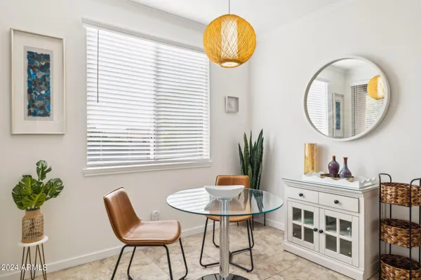 a view of a dining room with furniture and a potted plant