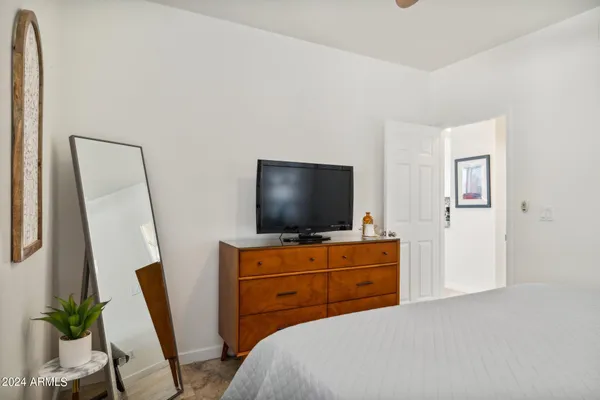 a bedroom with a bed and a flat screen tv
