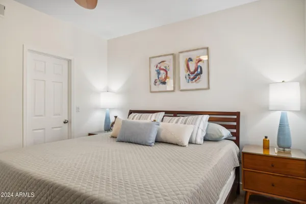 a bedroom with a bed and a desk