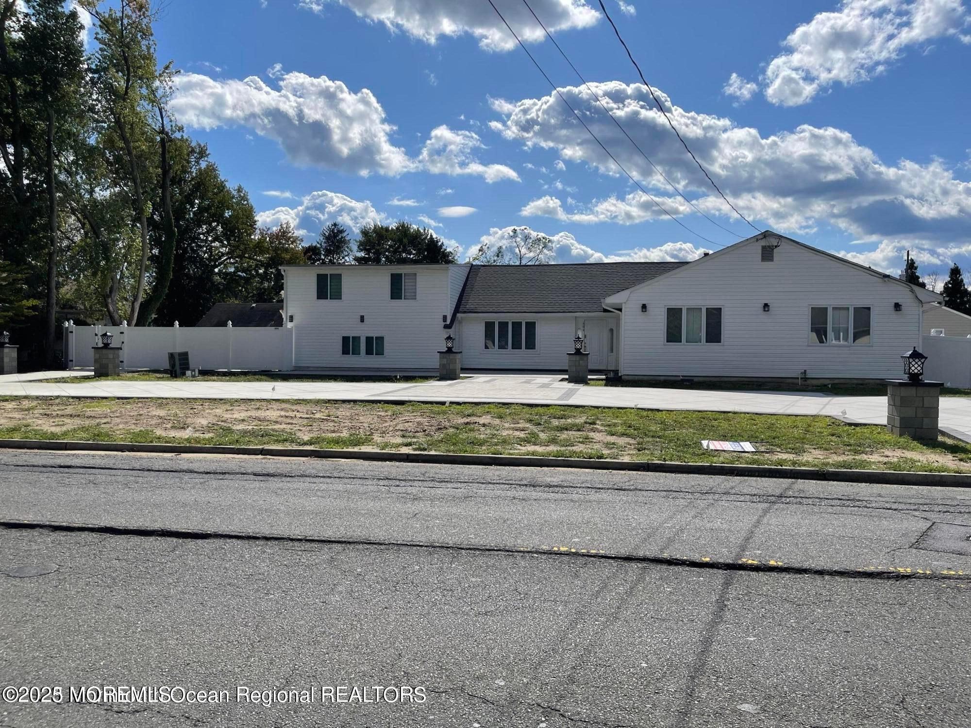 a house view with a swimming pool and yard