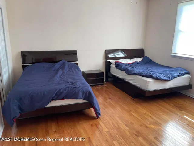 a bedroom with a bed and a night stand