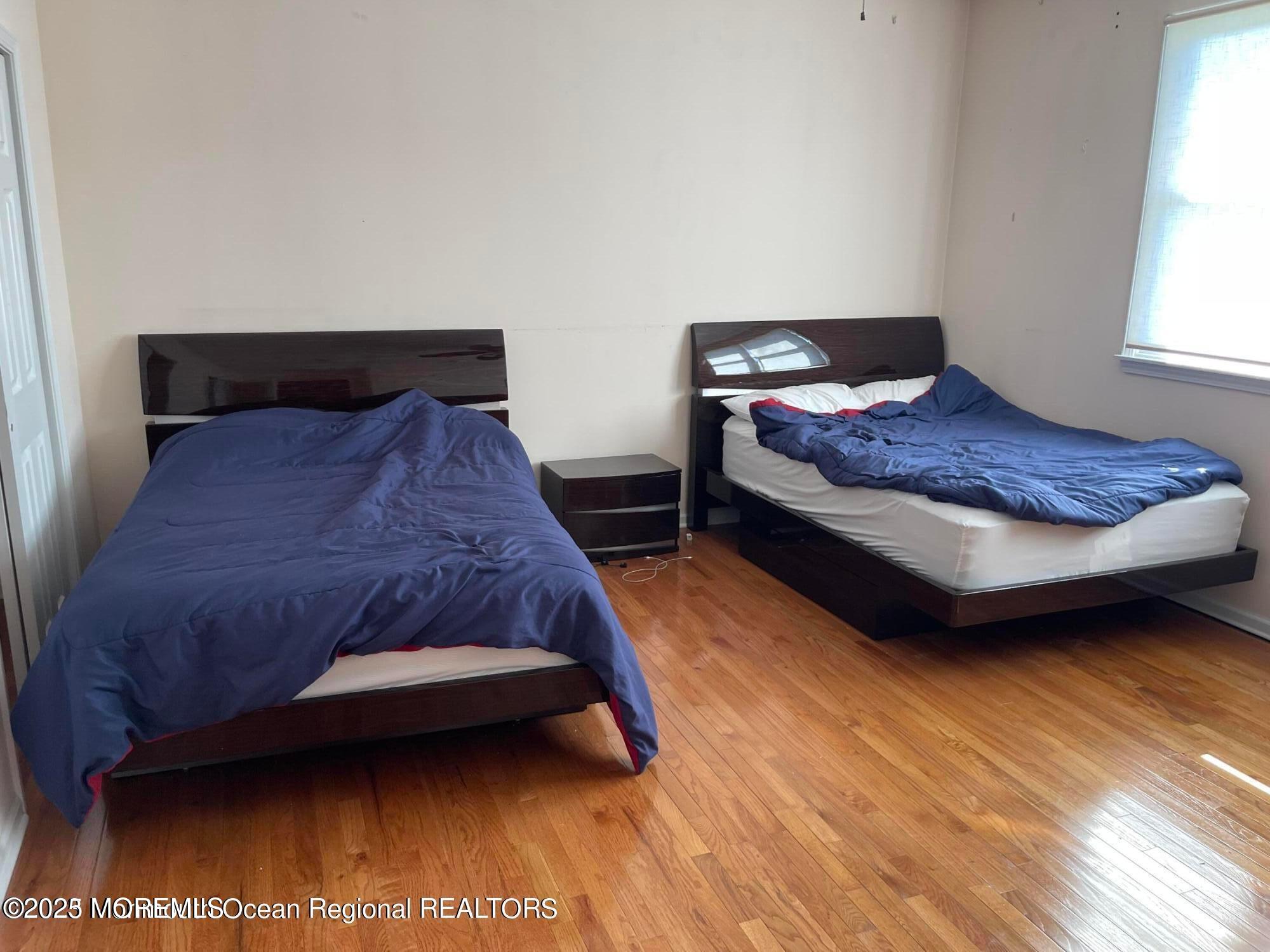 404 Deal Road Asbury Park, NJ 07712 - Photo 10 of 11 a bedroom with a bed and a night stand