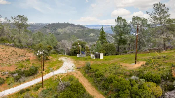 an aerial view of a house with a yard