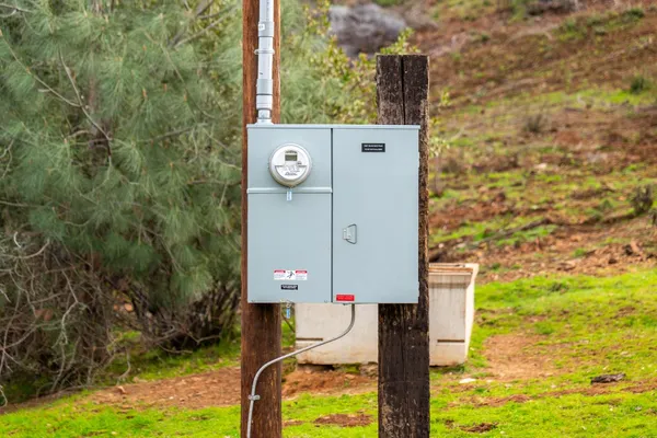 a view of a dry yard with mountains in the background