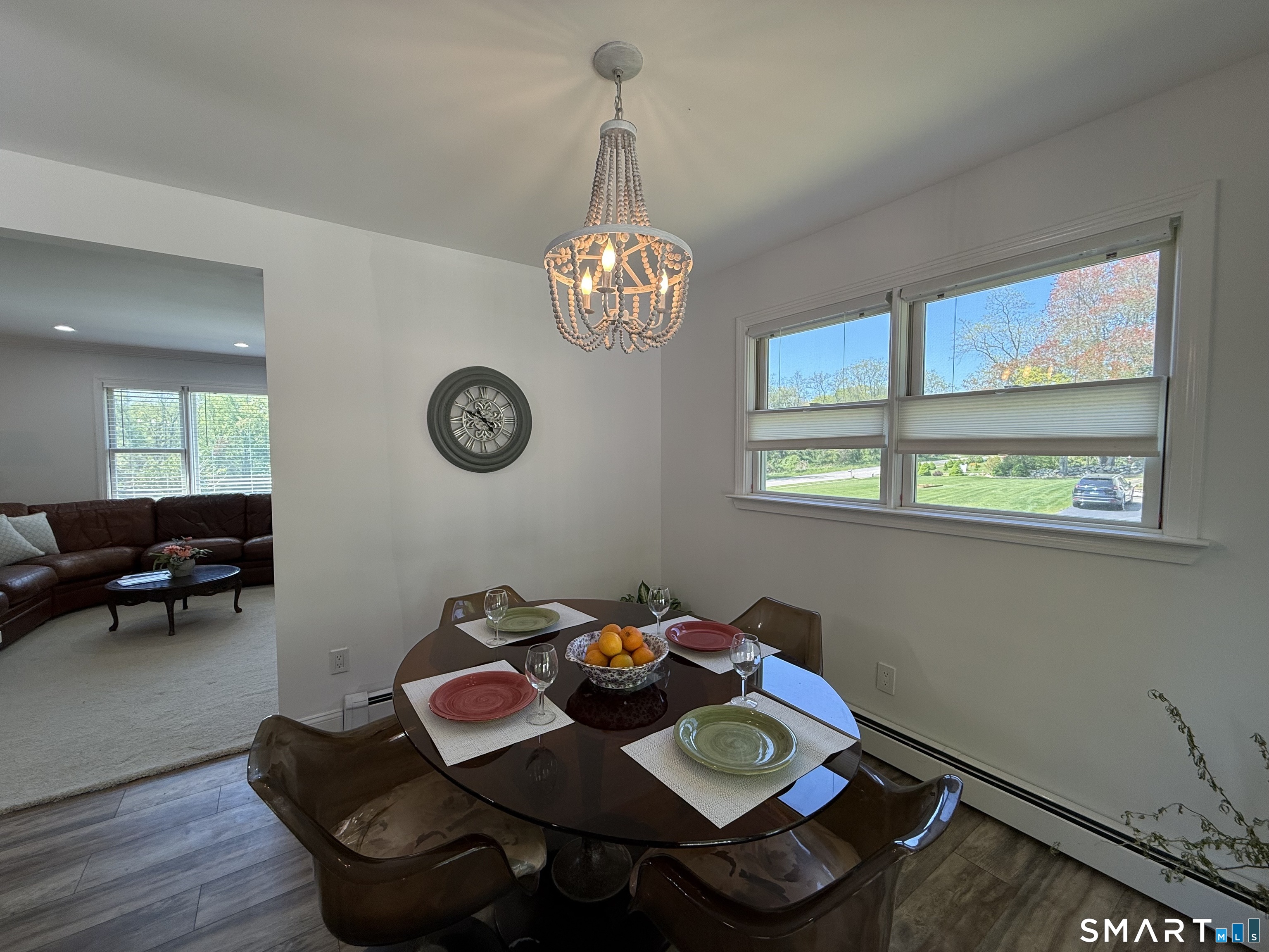 29 Deer Ridge Road Stonington, CT 06378 - Photo 27 of 35 a view of a dining room with furniture a chandelier and wooden floor