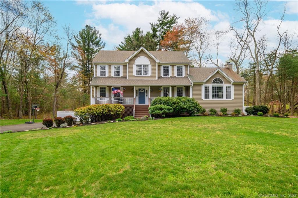 89 New Lebbon Road Newtown, CT 06482 - Photo 1 of 1 a front view of a house with a garden and trees