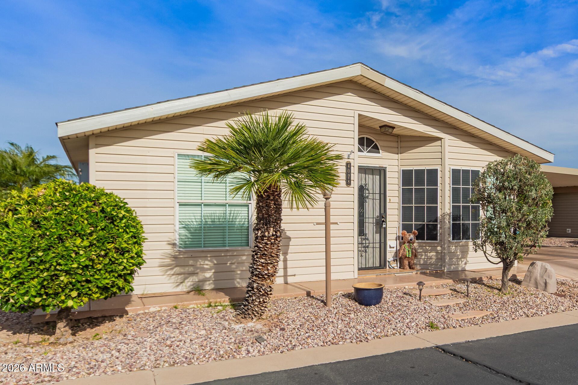3301 South Goldfield Road, Unit 4028 Apache Junction, AZ 85119 - Photo 14 of 43 a front view of house with yard and seating space