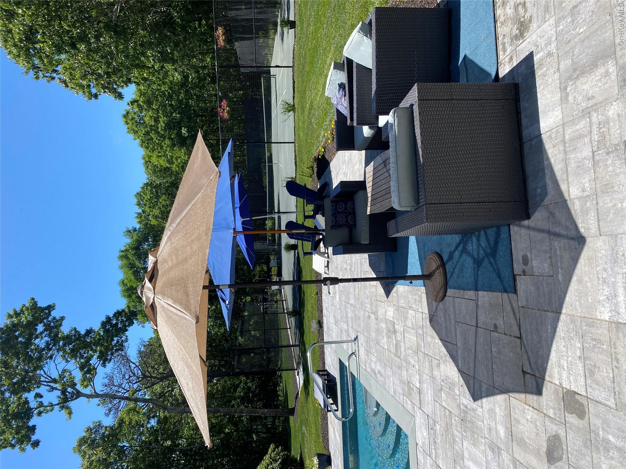 27 Deer Path Quogue, NY 11959 - Photo 1 of 44 a patio with patio table and chairs