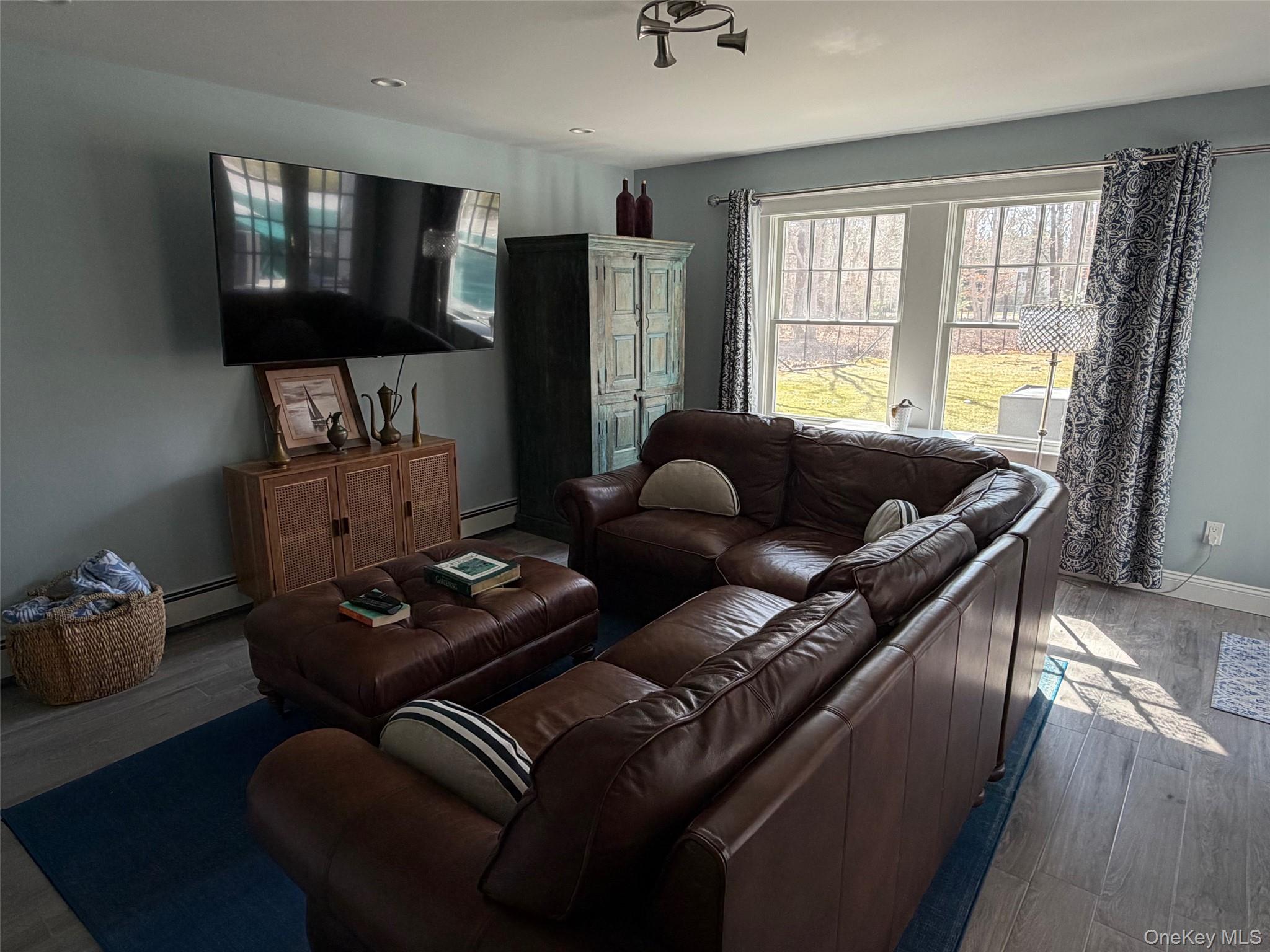 27 Deer Path Quogue, NY 11959 - Photo 17 of 44 a living room with furniture and a window