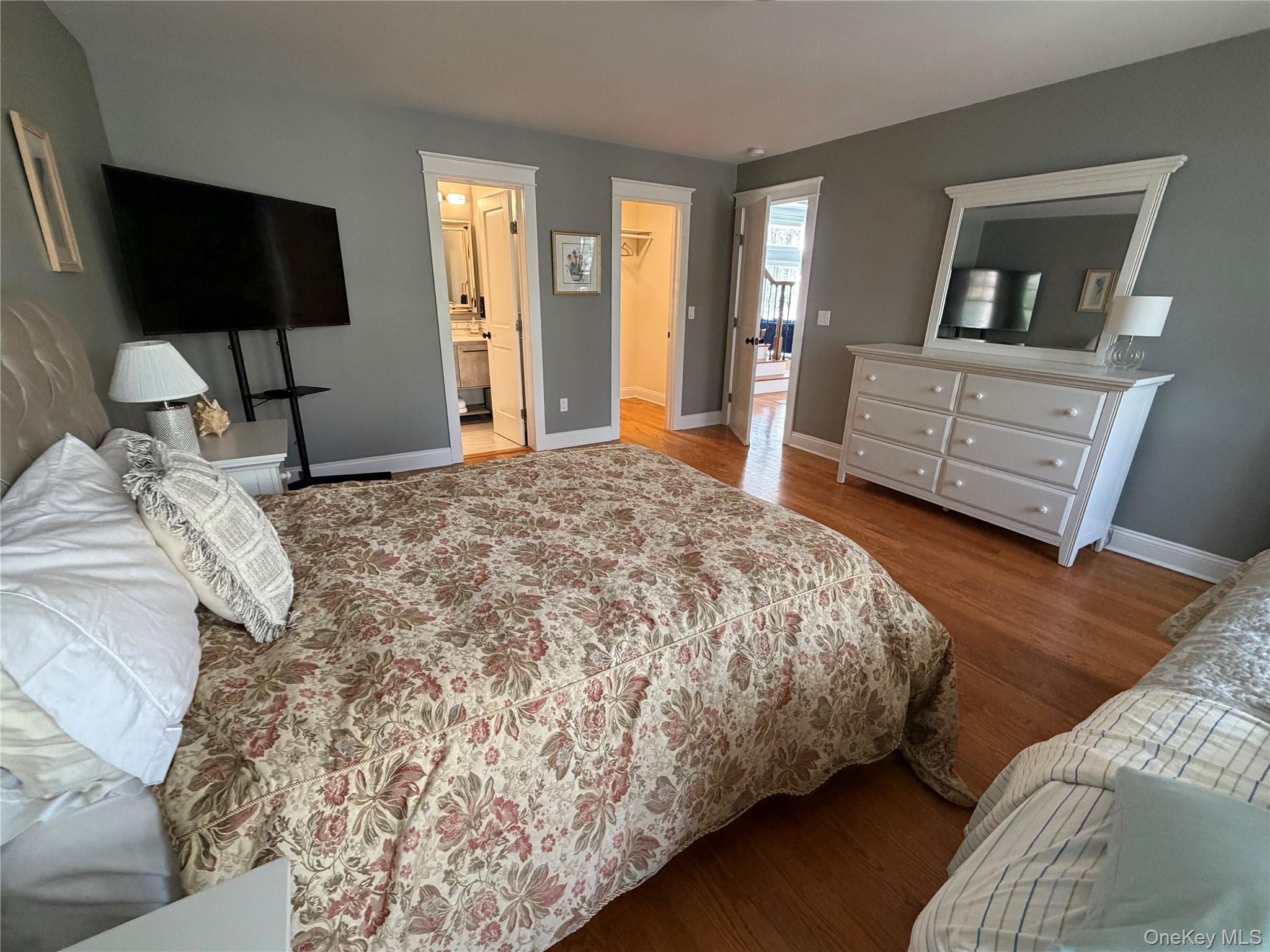 27 Deer Path Quogue, NY 11959 - Photo 23 of 44 a bedroom with a bed and a television
