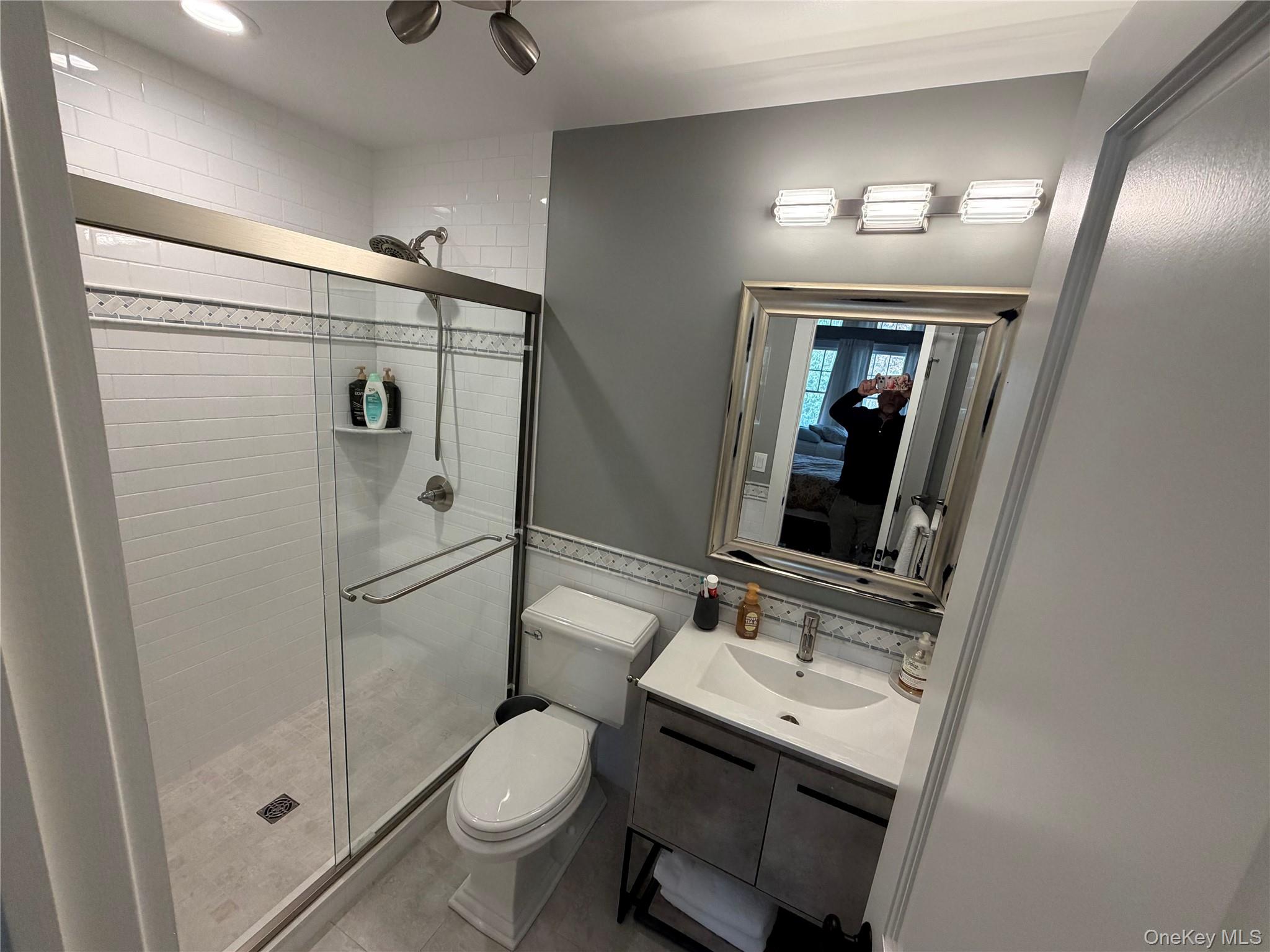27 Deer Path Quogue, NY 11959 - Photo 24 of 44 a bathroom with a sink toilet and shower