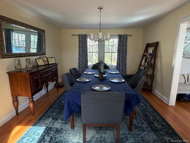 27 Deer Path Quogue, NY 11959 - Photo 27 of 44 a view of a dining room with furniture window and wooden floor
