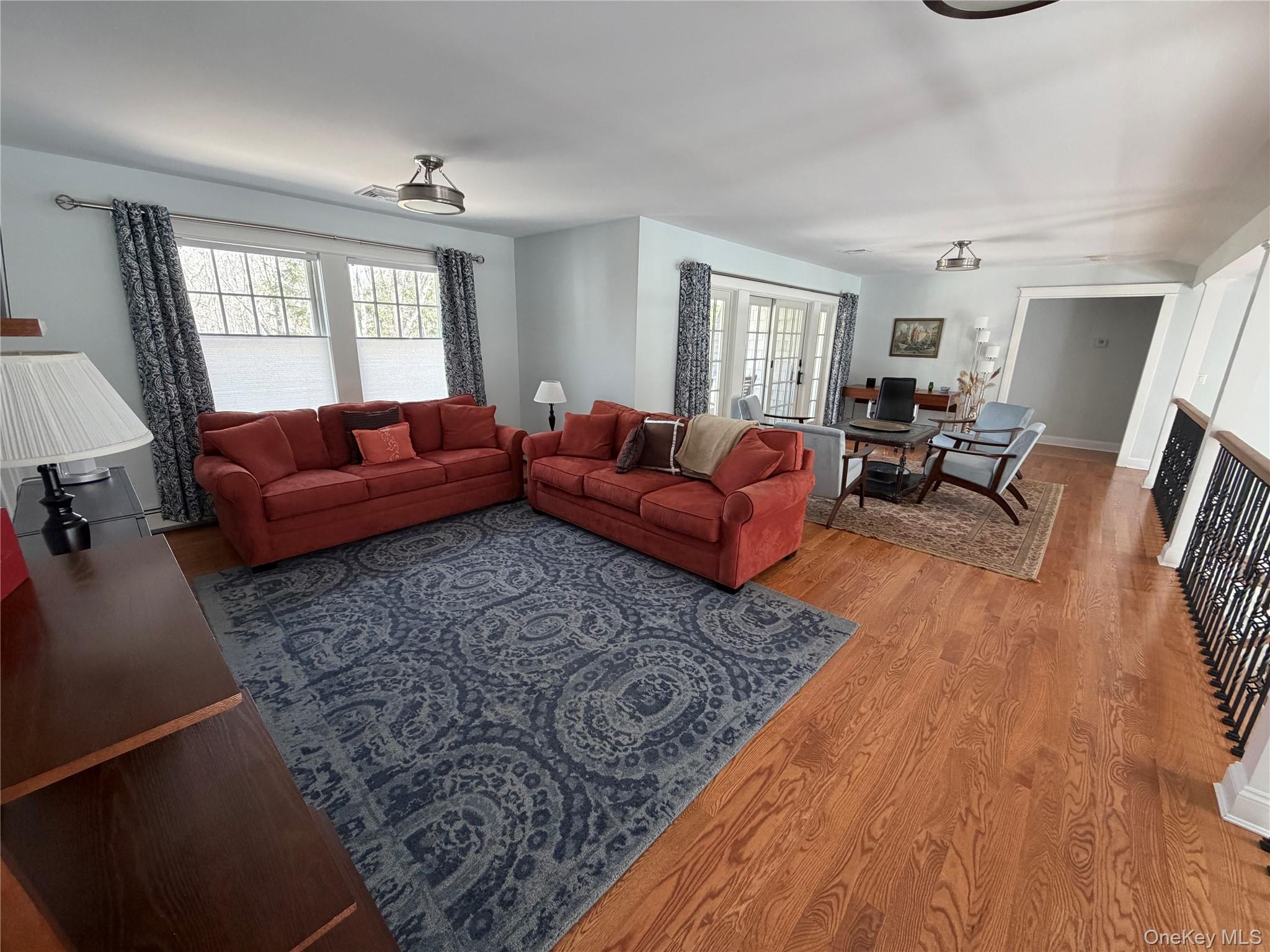 27 Deer Path Quogue, NY 11959 - Photo 3 of 44 a living room with furniture and a wooden floor