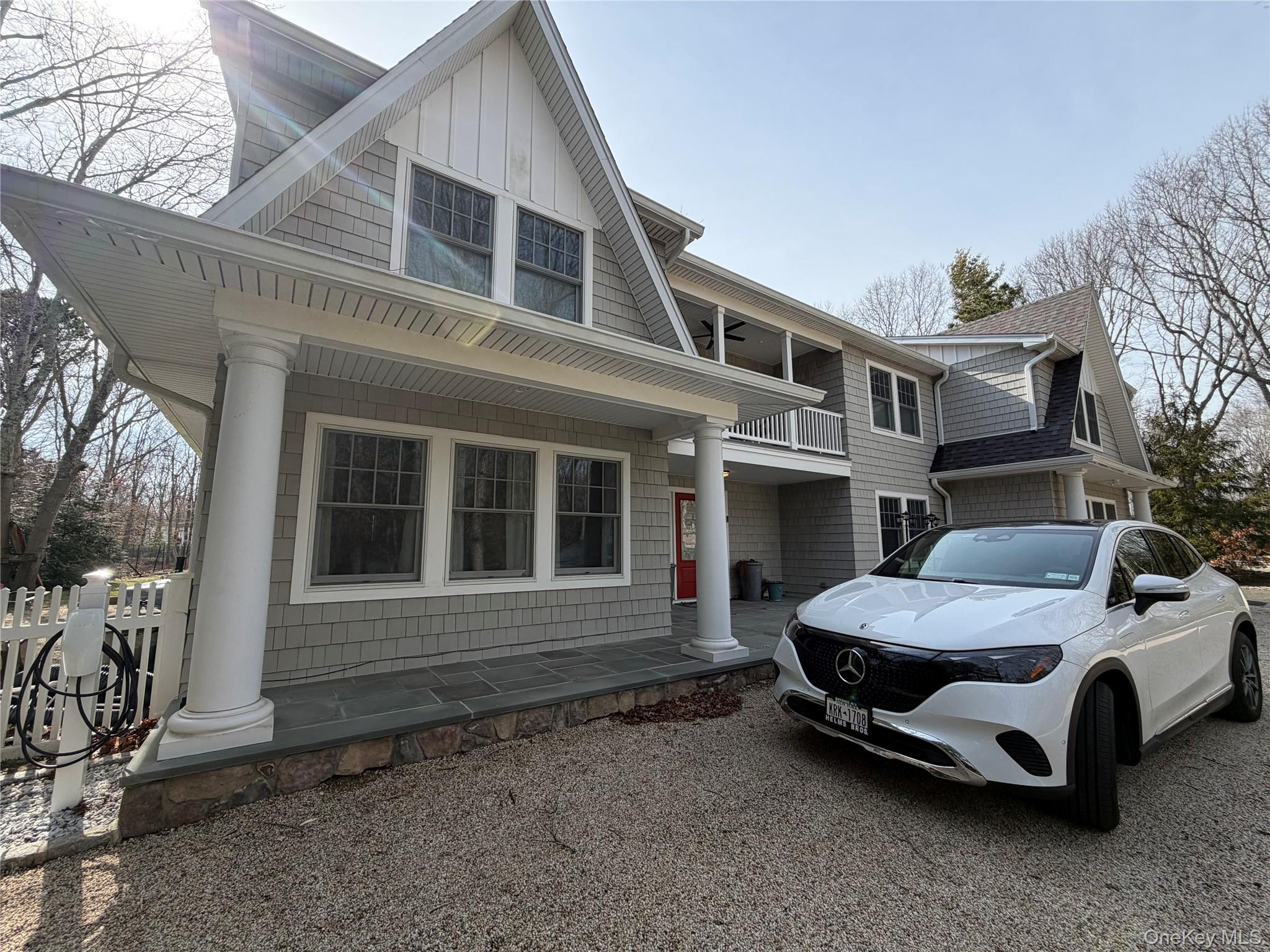 27 Deer Path Quogue, NY 11959 - Photo 34 of 44 a car parked in front of white house