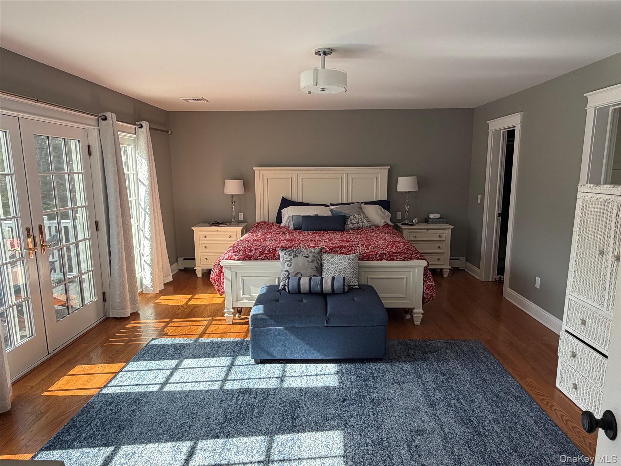 27 Deer Path Quogue, NY 11959 - Photo 36 of 44 a bedroom with a bed and a mirror on dresser